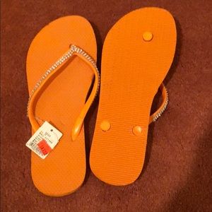 orange sparkley flip flops